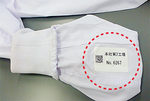 ユニフォームの袖にネームラベルを用いて装着されたRFID耐洗タグ。熱プレスでラベルがユニフォームの生地に強力に溶着するため、外れる心配がない
