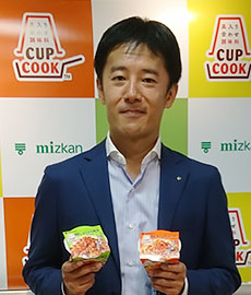 「CUPCOOK」を手にする、Mizkan田中祐之取締役ＭＤ本部長