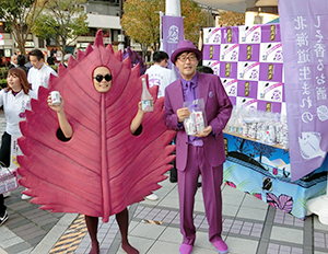 「鍛高譚」をイメージした紫色のスーツをきた西永裕司社長（右）とシソマン
