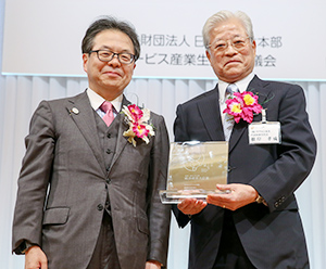 受賞式に出席した根岸孝成社長（右）と世耕弘成経済産業大臣
